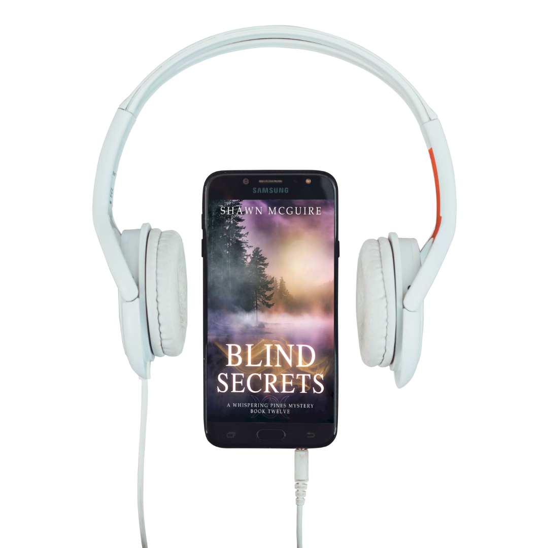 Audiobook cover on cellphone of Shawn McGuire's cozy murder mystery series set in Whispering Pines, featuring a lake shrouded in fog.
