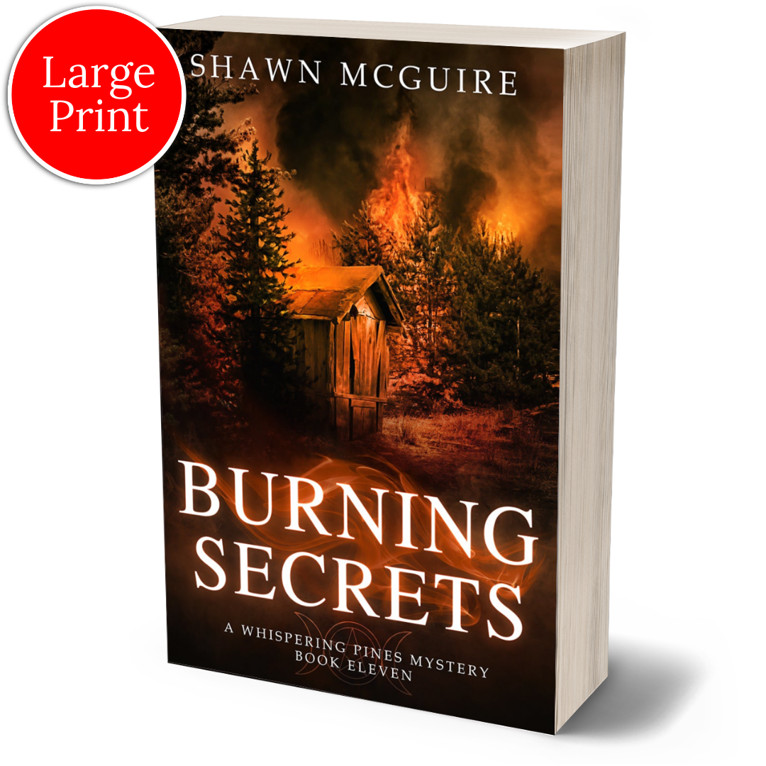 Cover of large print paperback version of Shawn McGuire's cozy murder mystery set in Whispering Pines, featuring a burning forest and shack.