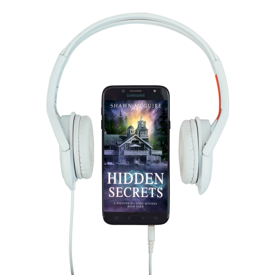 Audiobook cover on cellphone of Shawn McGuire's cozy murder mystery featuring a beautiful house on a lake.