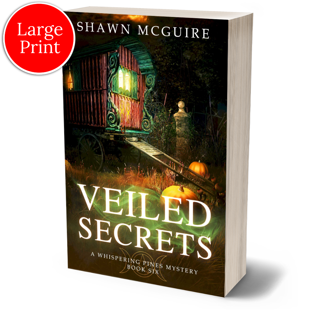 Large print paperback cover of Shawn McGuire's cozy murder mystery featuring a fortune teller’s wagon and Halloween pumpkins.