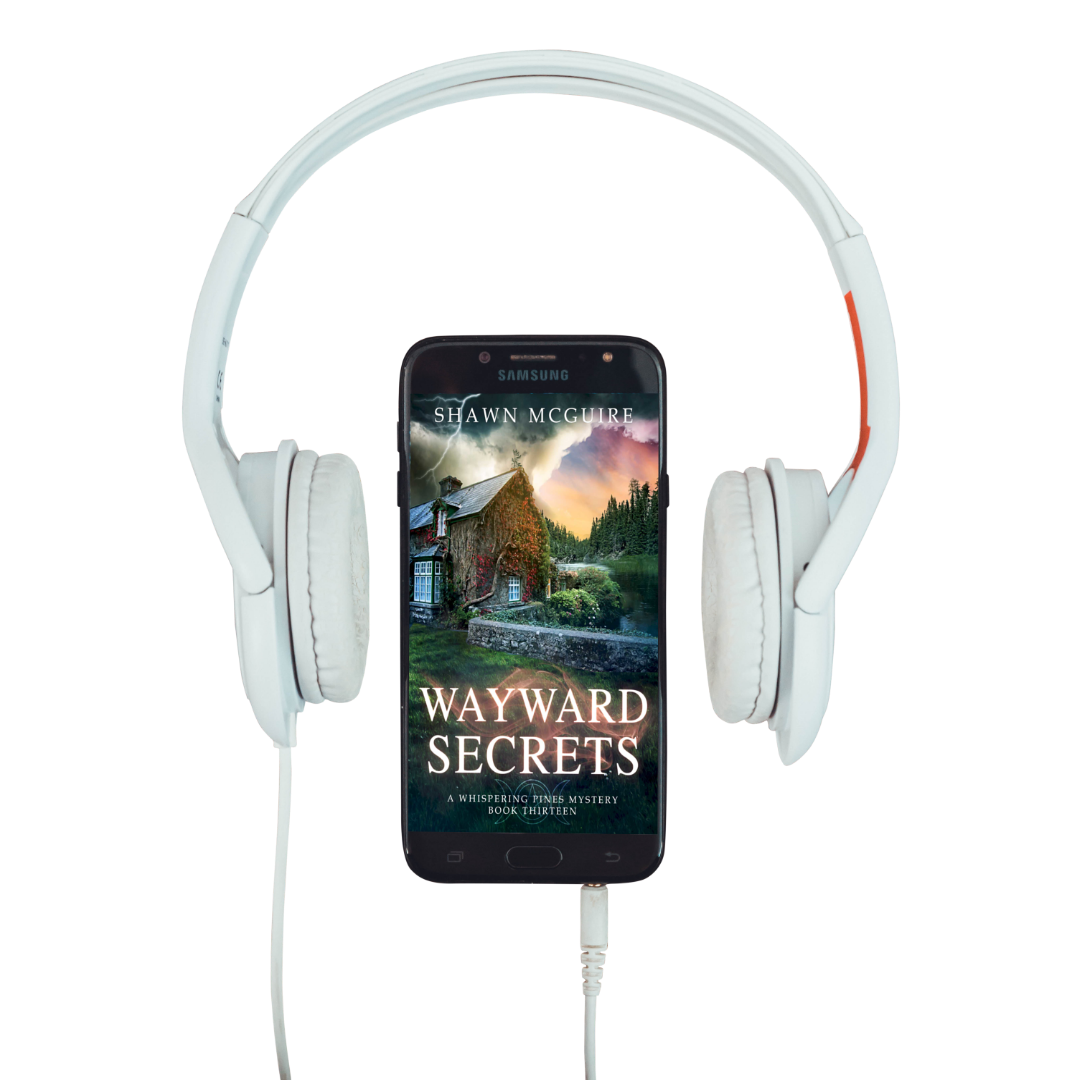 Audiobook cover on cellphone of Shawn McGuire's cozy murder mystery featuring a stone cottage on a lake beneath an ominous sky.