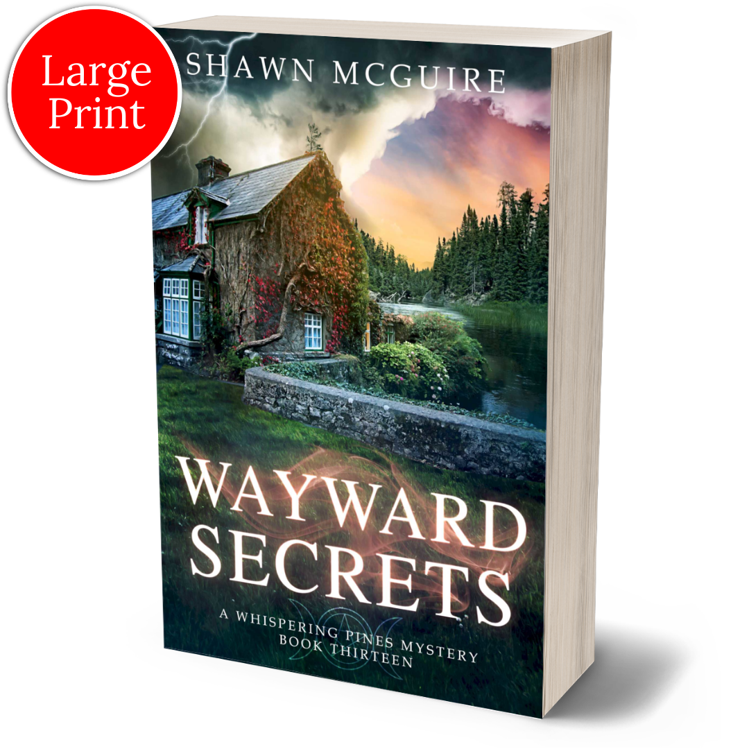 Large print paperback cover of Shawn McGuire's cozy murder mystery featuring a stone cottage on a lake beneath an ominous sky.