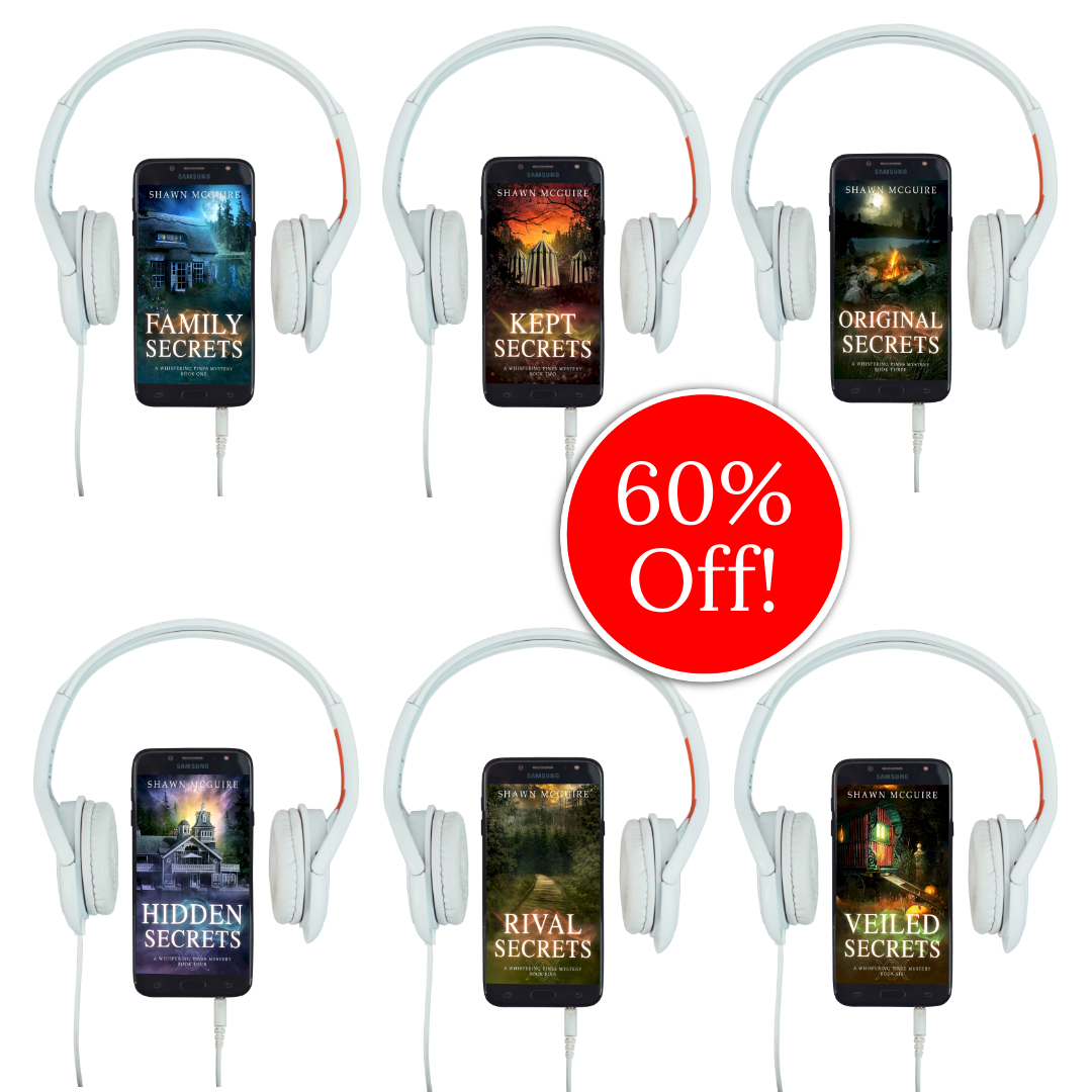 Audiobook covers on cellphones of Shawn McGuire’s 13-book cozy murder mystery series collection books 1-6.