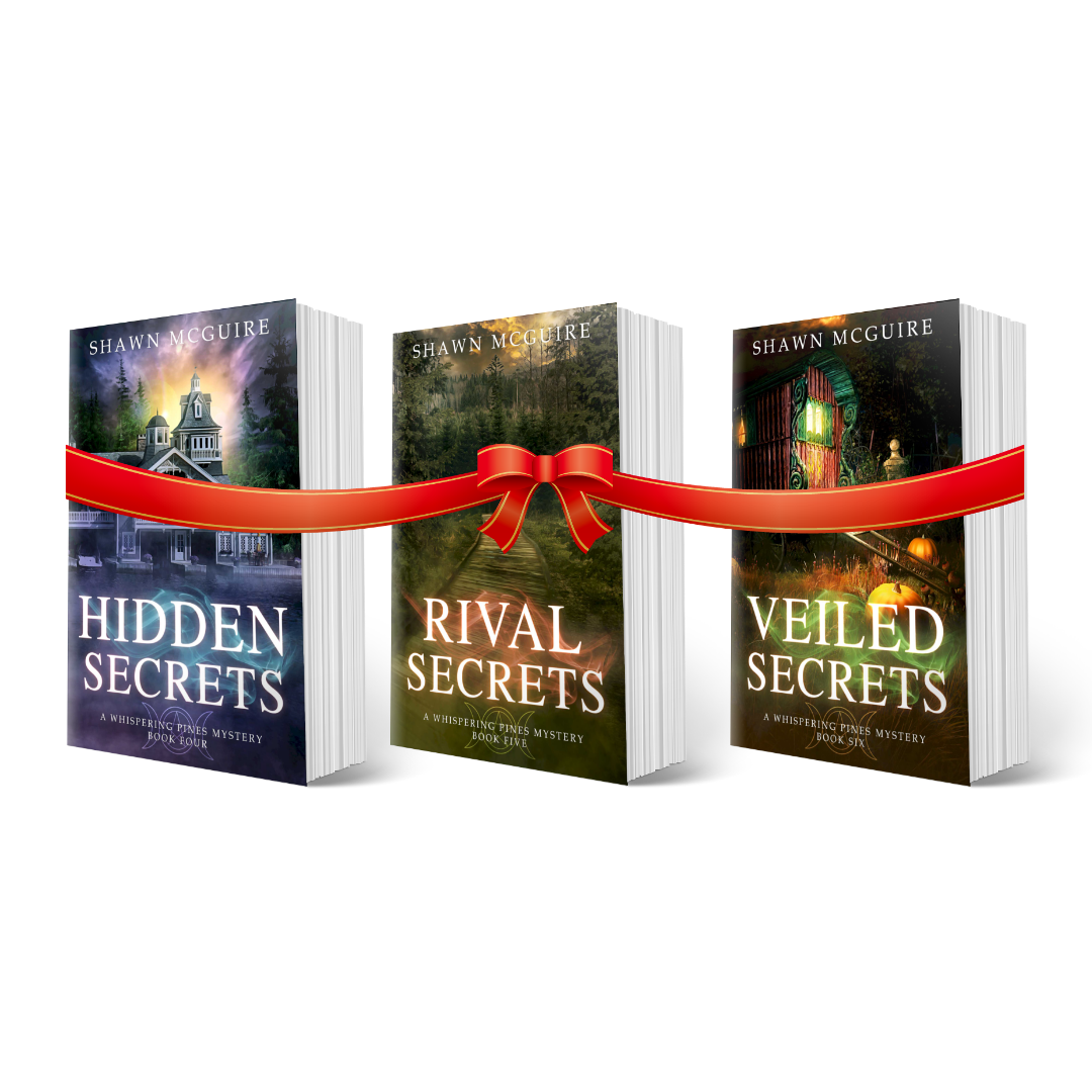 Three books titled 'Hidden Secrets', 'Rival Secrets', and 'Veiled Secrets' by Shawn McGuire tied together with a red ribbon on a white background.