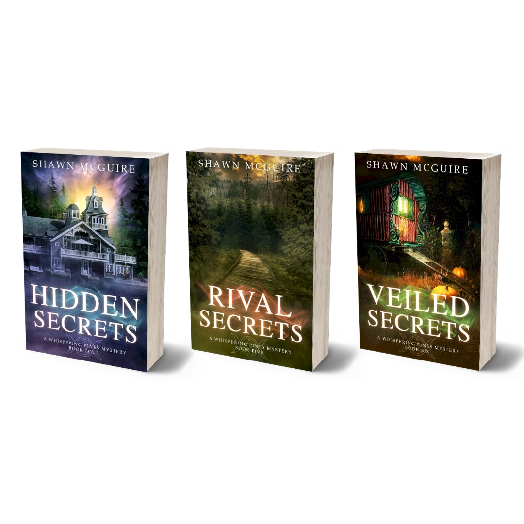 A set of three Whispering Pines paperbacks, books 4-6, standing upright with their covers visible. The book covers feature a mystical and dramatic village setting with elements of mystery.