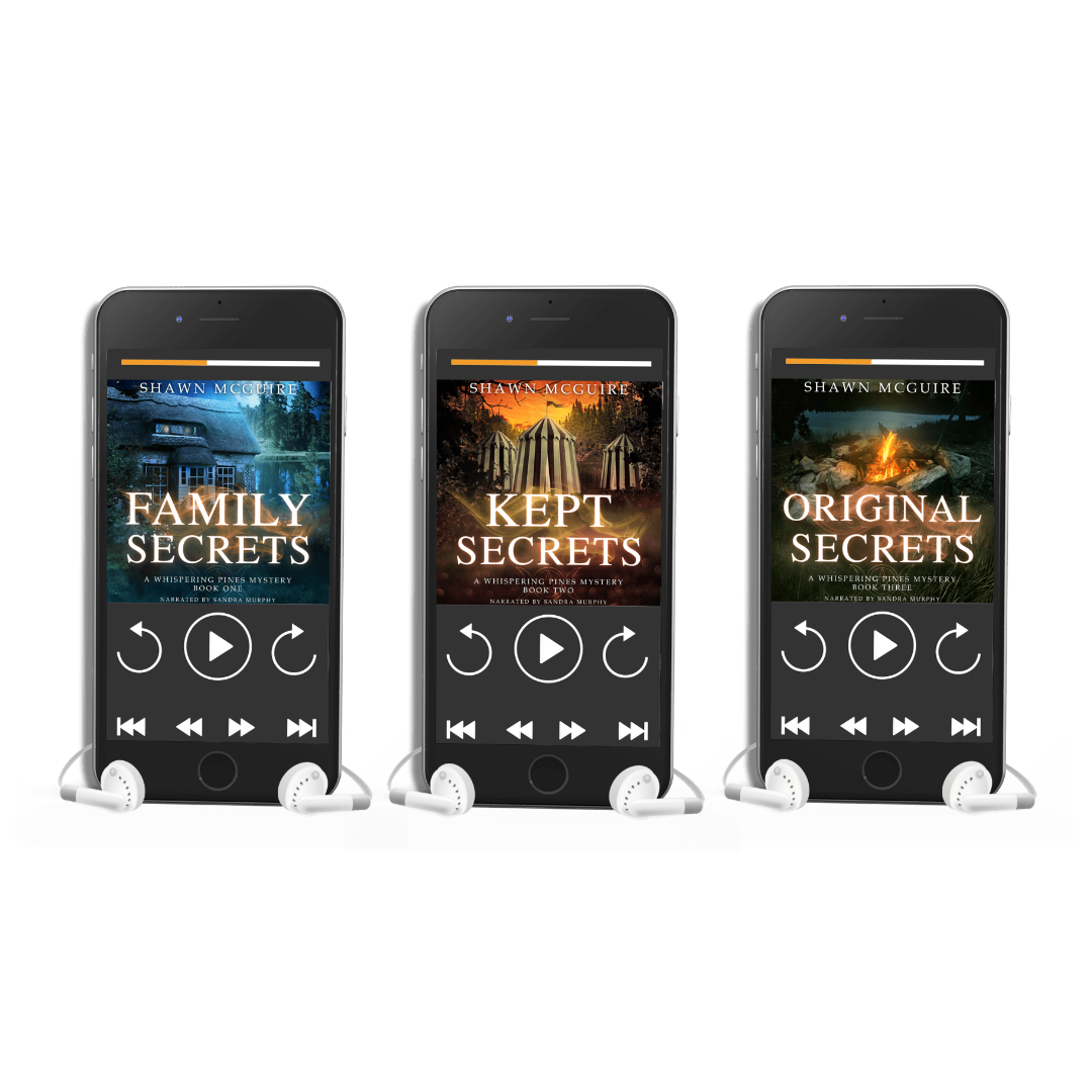 Three smartphones displaying the paranormal cozy mystery book covers of 'Family Secrets', 'Kept Secrets', and 'Original Secrets' by Shawn McGuire.