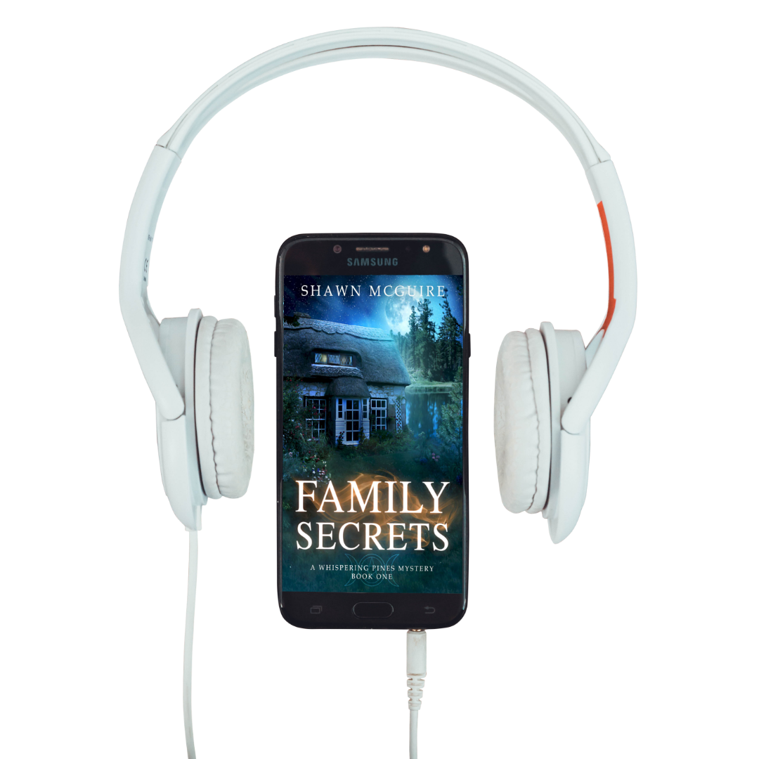 White headphones with a smartphone displaying 'Family Secrets' book cover