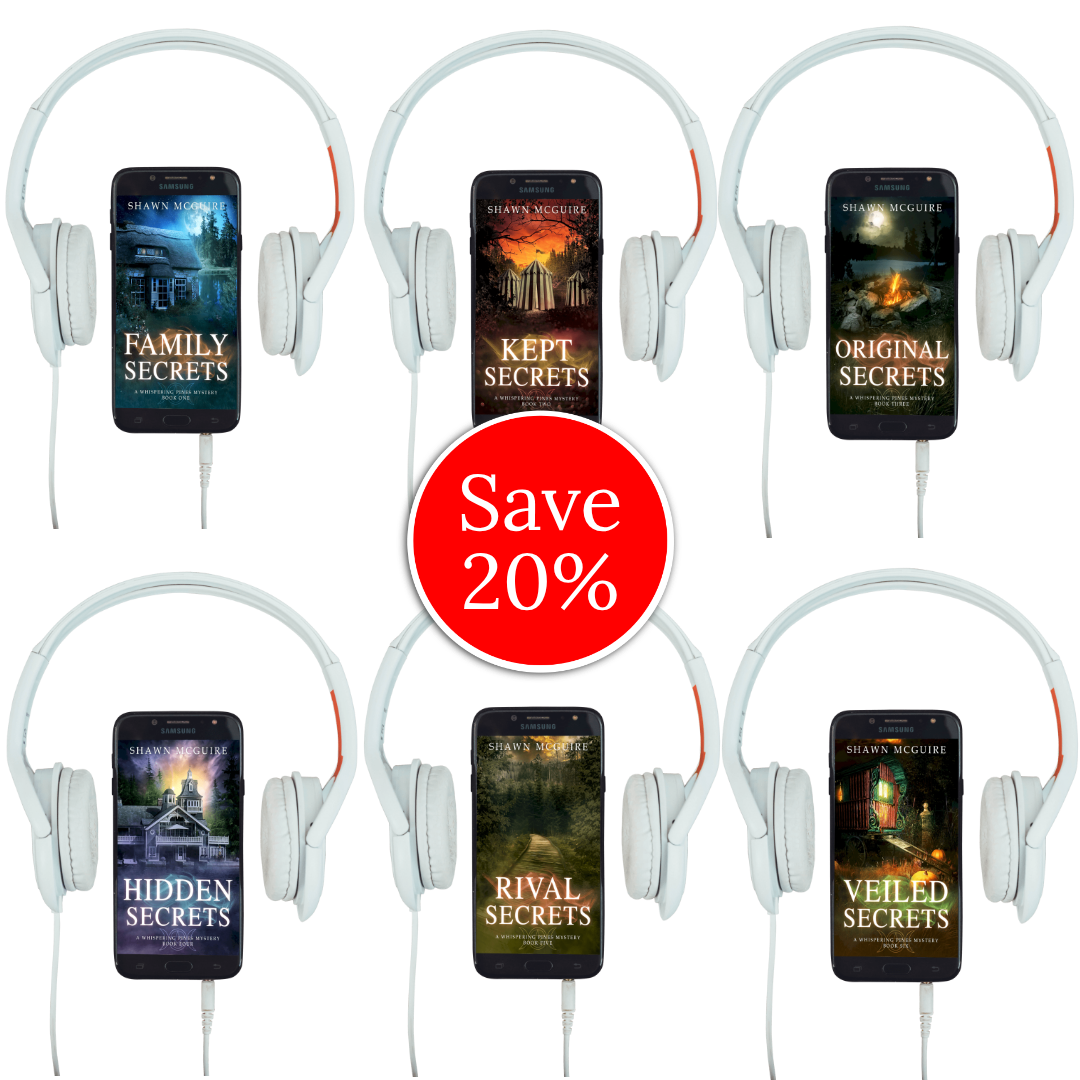 Audiobook covers on cellphones of Shawn McGuire’s Whispering Pines cozy murder mystery series collection books 1-6.