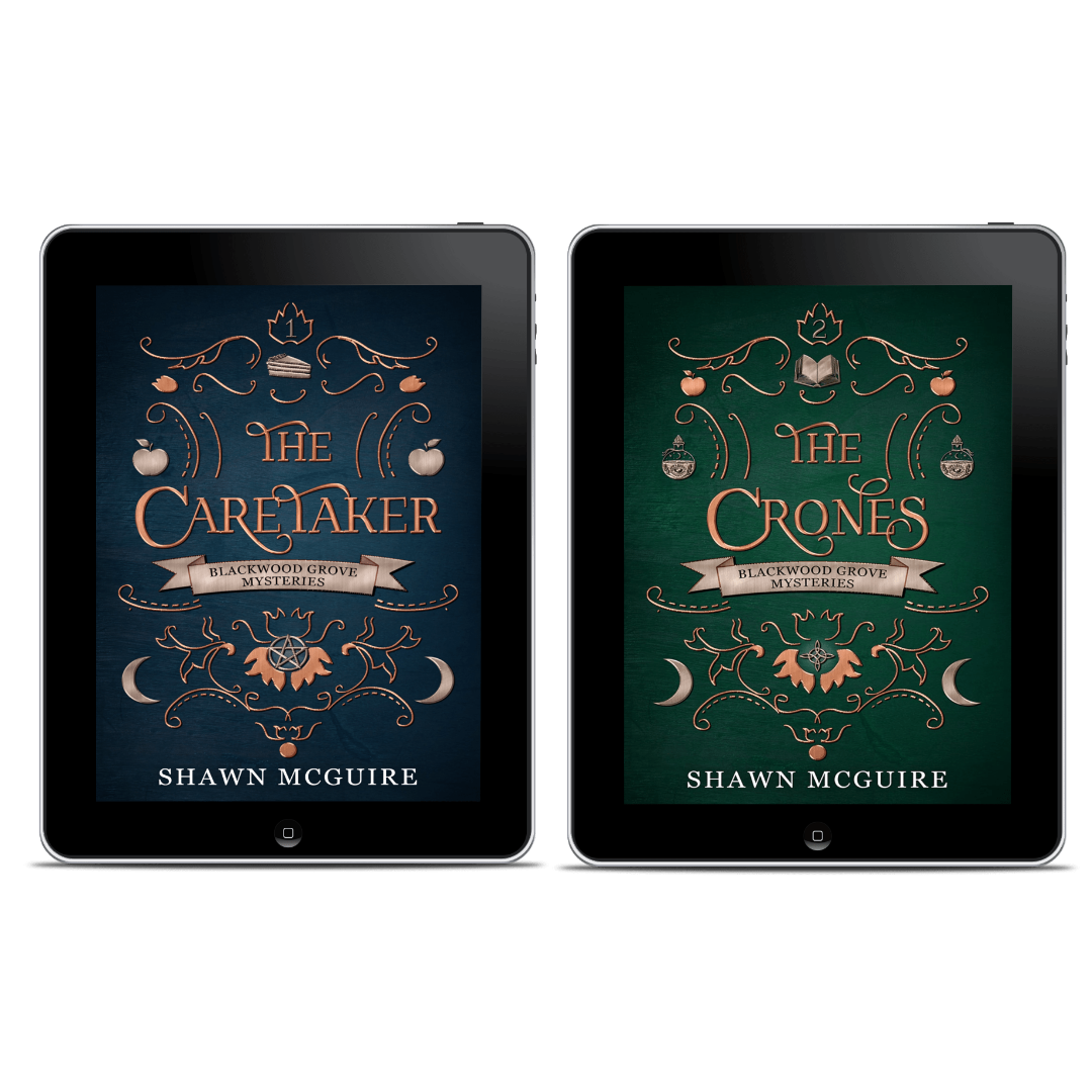 Two tablets displaying book covers of 'The Caretaker' and 'The Crones' by Shawn McGuire.