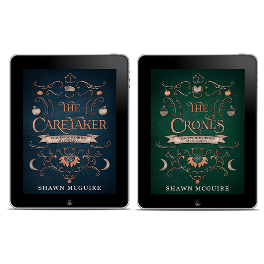 Two tablets displaying book covers of 'The Caretaker' and 'The Crones' by Shawn McGuire.