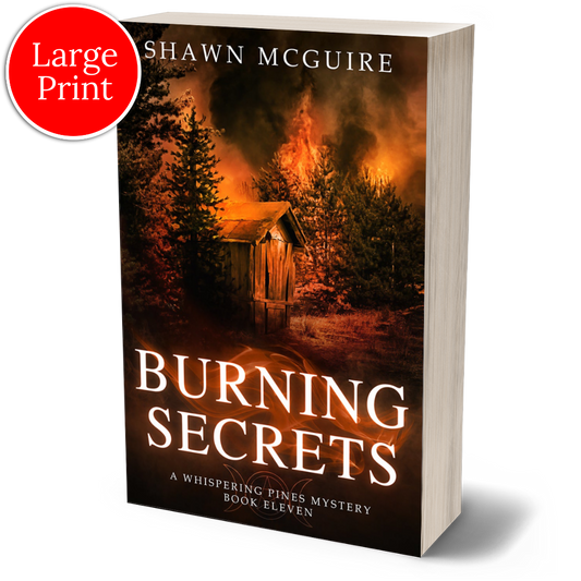 Cover of large print paperback version of Shawn McGuire's cozy murder mystery set in Whispering Pines, featuring a burning forest and shack.