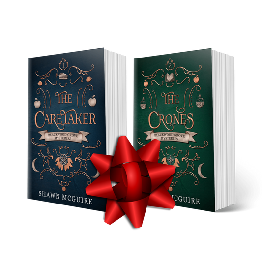 Two books titled 'The Caretaker' and 'The Crones' from Shawn McGuire's Witches of Blackwood Grove paranormal mystery series with a red bow between them on a white background.