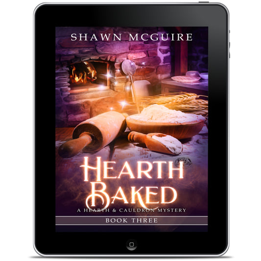 E-book cover on e-reader of Shawn McGuire’s witch cozy midlife mysteries with a fireplace in background and large rolling pin. 