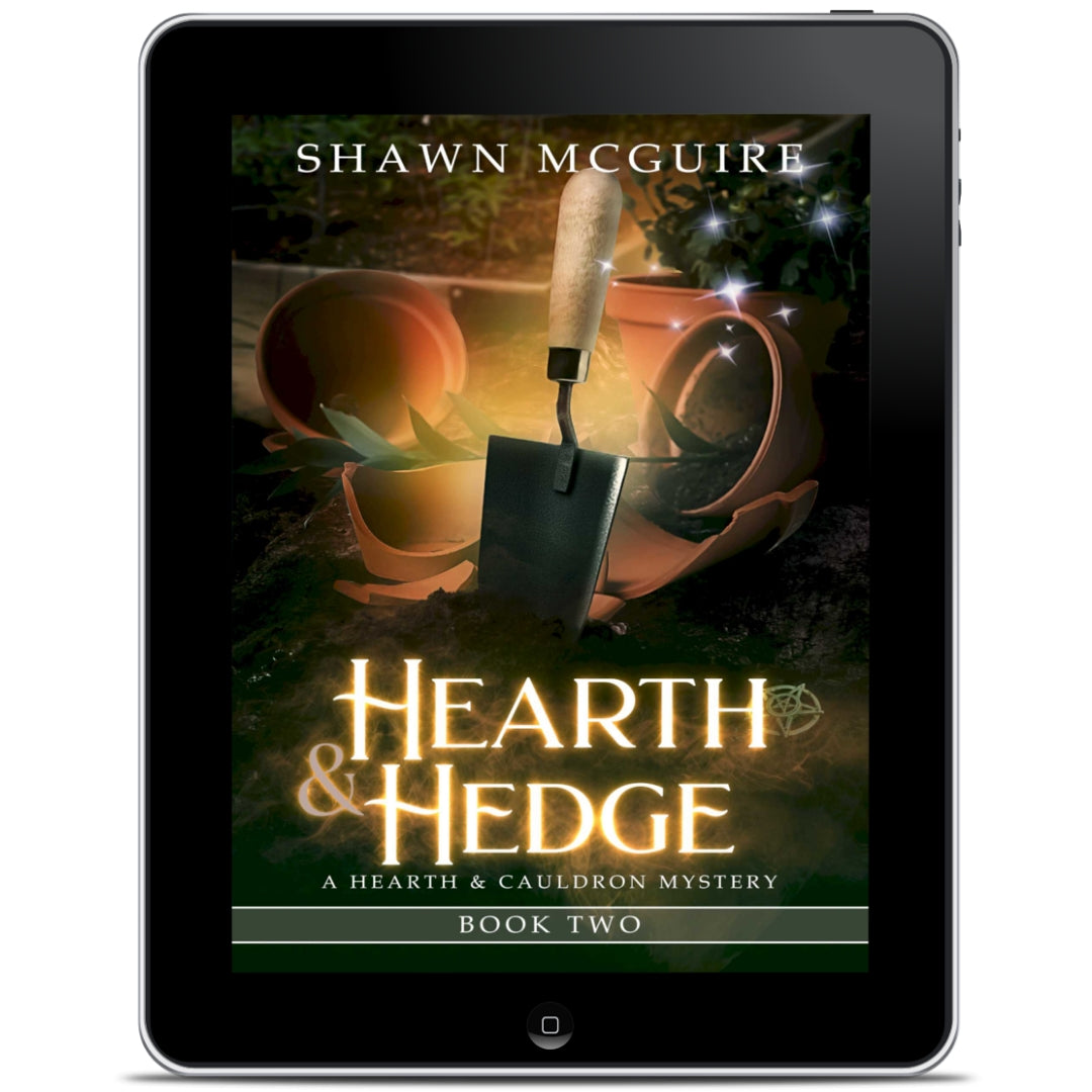 E-book cover on e-reader of Shawn McGuire’s witch cozy midlife mysteries with broken plant pots and a hand trowel. 