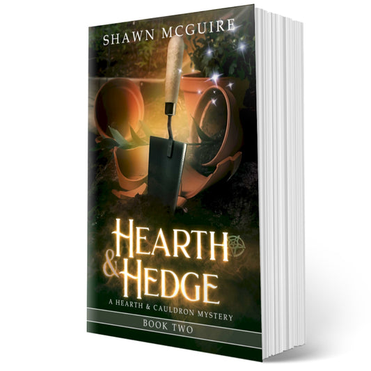 Cover of Shawn McGuire’s witch cozy midlife mysteries with broken plant pots and a hand trowel. 