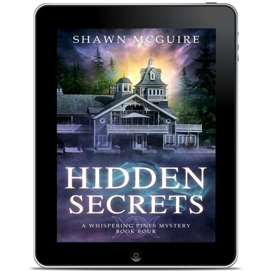 E-book cover on e-reader of Shawn McGuire's cozy murder mystery featuring a beautiful house on a lake.