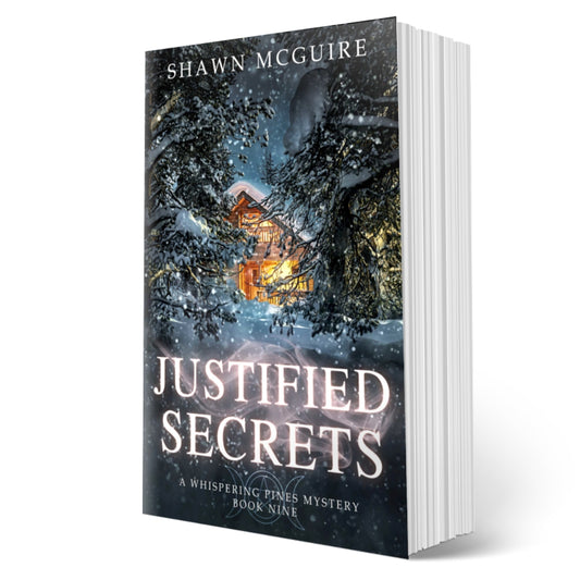 Cover of Shawn McGuire's cozy murder mystery featuring a cabin in the woods during a snowstorm.