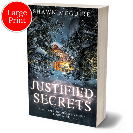 Large print paperback cover of Shawn McGuire's cozy murder mystery featuring a cabin in the woods during a snowstorm.