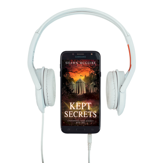 Audiobook cover on cellphone for Shawn McGuire’s cozy murder mystery series set in Whispering Pines, featuring a mysterious woodland circus.