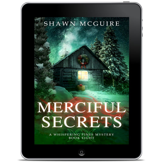Audiobook cover on cellphone of Shawn McGuire's cozy murder mystery featuring a cabin in the woods during Yule.