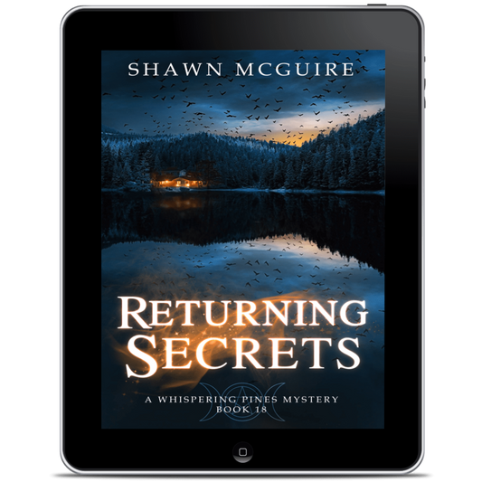 E-book cover on e-reader of Shawn McGuire’s cozy mystery with an image of a house on a lake surrounded by pine trees and a flock of crows in the sky. 