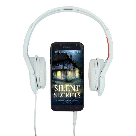 Audiobook cover on cellphone of Shawn McGuire's cozy murder mystery featuring a pub on a cobbled pathway.