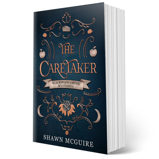 Cover of Shawn McGuire’s witch cozy paranormal midlife mystery series blue background with scrollwork and apples, moons, and slice of pie icons.