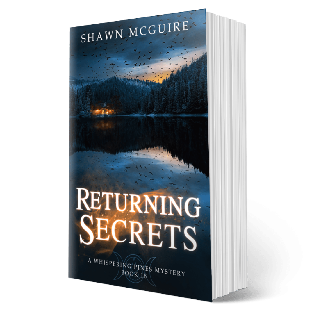 Paperback book titled 'Returning Secrets' by Shawn McGuire with a lake, pine forest, and flock of crows on cover.